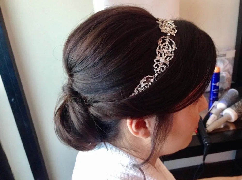 An elegant bridal updo with a jeweled hairpiece