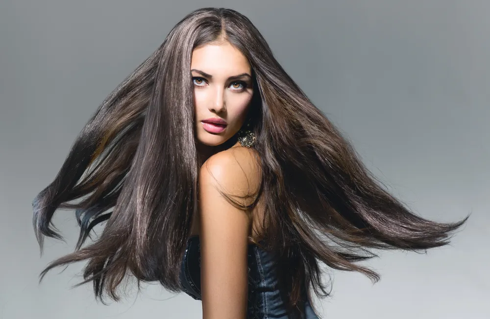 A client with long brunette waves, photographed in the studio